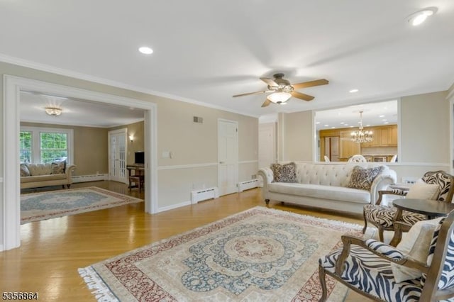 147 Liberty Corner Rd, Bernards Twp, NJ 07920 - living room featuring a baseboard radiator, ornamental molding, a chandelier, a ceiling fan, and light wood-style floors