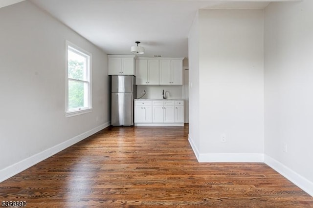 1673 Raritan Rd, Clark Twp, NJ 07066 - kitchen featuring freestanding refrigerator, dark wood-style floors, baseboards, and white cabinets