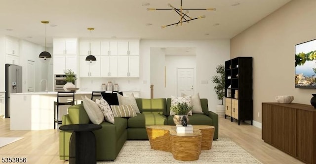 living area with light wood finished floors and a chandelier