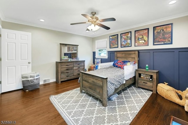 bedroom featuring wood finished floors, ornamental molding, recessed lighting, ceiling fan, and a wainscoted wall