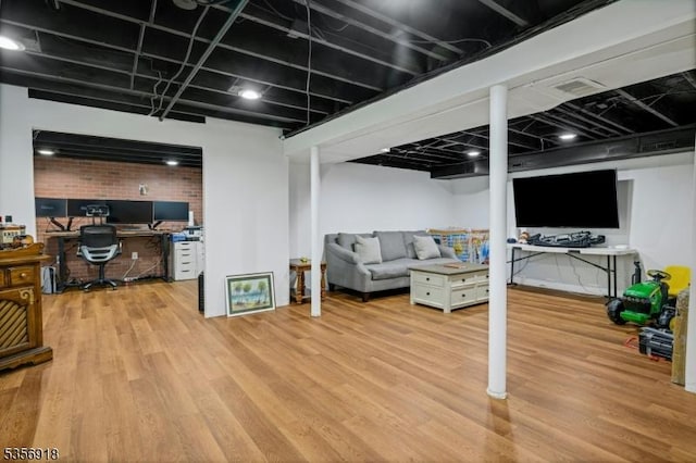 finished below grade area with a desk and wood finished floors