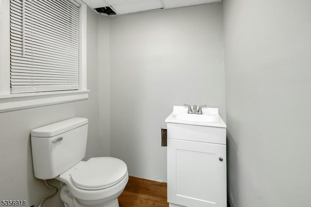 bathroom featuring toilet, wood finished floors, and vanity