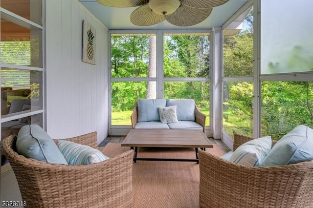 sunroom / solarium with a ceiling fan and outdoor lounge area