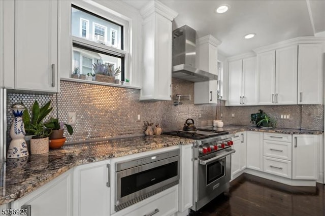 12 Harrison Ave, Montclair Twp, NJ 07042 - kitchen featuring wall chimney range hood, appliances with stainless steel finishes, white cabinets, dark wood-type flooring, and recessed lighting