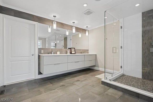 full bathroom with a stall shower, double vanity, baseboards, and recessed lighting