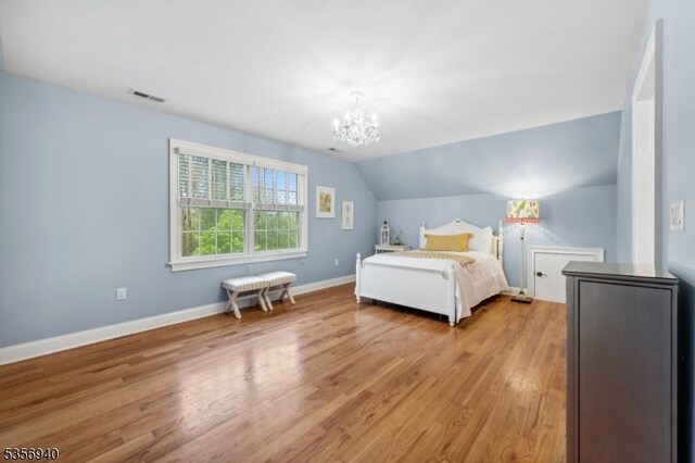 28 Handler Ct, Montgomery Twp, NJ 08502 - bedroom featuring light wood-style flooring, a chandelier, lofted ceiling, and baseboards