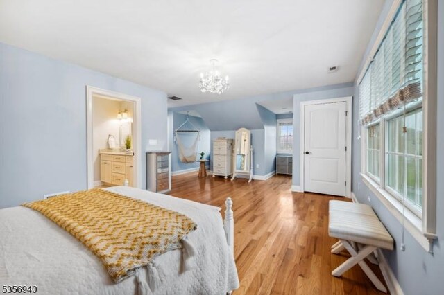 28 Handler Ct, Montgomery Twp, NJ 08502 - bedroom featuring a chandelier, baseboards, light wood-style flooring, and ensuite bathroom