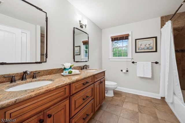 28 Handler Ct, Montgomery Twp, NJ 08502 - full bath featuring toilet, double vanity, a shower with shower curtain, and baseboards