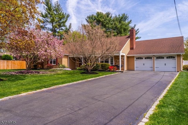3 Larsen Rd, Franklin Twp, NJ 08873 - view of front of house with an attached garage, asphalt driveway, and a chimney