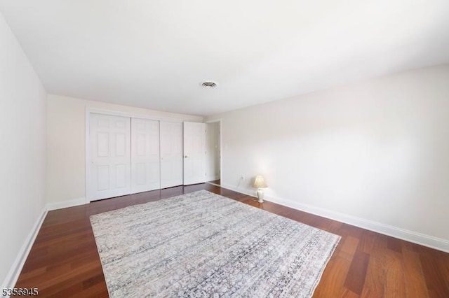 3 Larsen Rd, Franklin Twp, NJ 08873 - unfurnished bedroom featuring baseboards, dark wood-style floors, and a closet