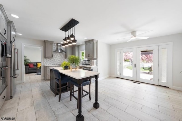 3 Larsen Rd, Franklin Twp, NJ 08873 - kitchen featuring gray cabinetry, wall chimney range hood, decorative backsplash, light countertops, and healthy amount of natural light