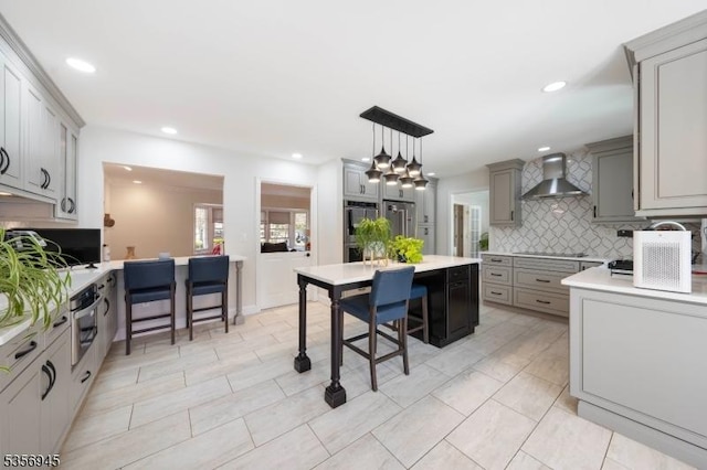 3 Larsen Rd, Franklin Twp, NJ 08873 - kitchen with wall chimney range hood, backsplash, gray cabinets, black electric cooktop, and light countertops
