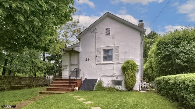 29 Oldham Rd, Wayne Twp, NJ 07470 - back of house with a chimney and a yard