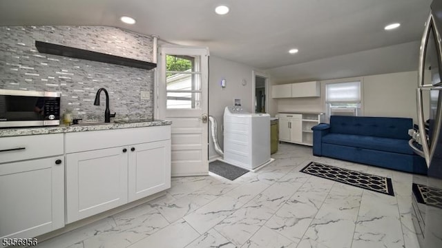 29 Oldham Rd, Wayne Twp, NJ 07470 - kitchen featuring stainless steel microwave, washer / clothes dryer, white cabinets, recessed lighting, and a sink