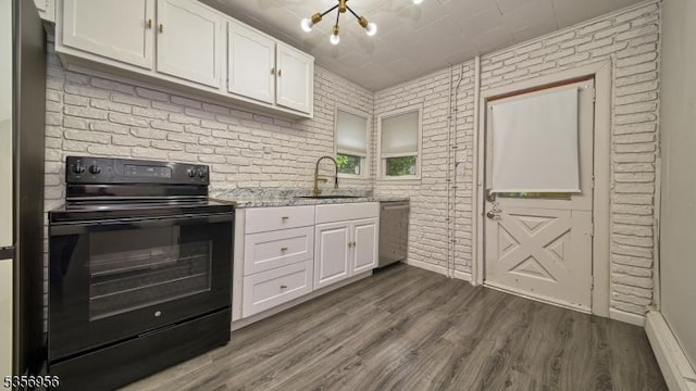 29 Oldham Rd, Wayne Twp, NJ 07470 - kitchen featuring black electric range oven, dishwasher, brick wall, a sink, and white cabinets