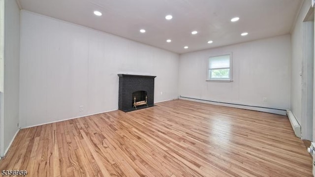 29 Oldham Rd, Wayne Twp, NJ 07470 - unfurnished living room with a baseboard heating unit, light wood-style floors, recessed lighting, a fireplace, and baseboard heating