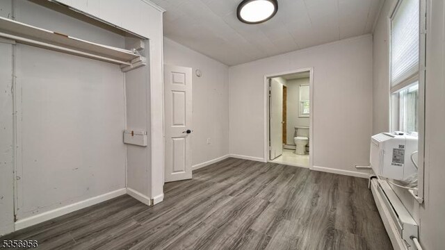 29 Oldham Rd, Wayne Twp, NJ 07470 - unfurnished bedroom with a baseboard heating unit, wood finished floors, and baseboards