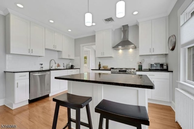 42 Mountain Ave, Mendham Boro, NJ 07945 - kitchen with wall chimney exhaust hood, stainless steel dishwasher, radiator heating unit, stove, and a sink