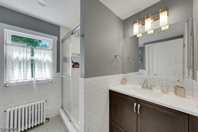 42 Mountain Ave, Mendham Boro, NJ 07945 - full bath with radiator heating unit, tile walls, a shower stall, vanity, and tile patterned floors