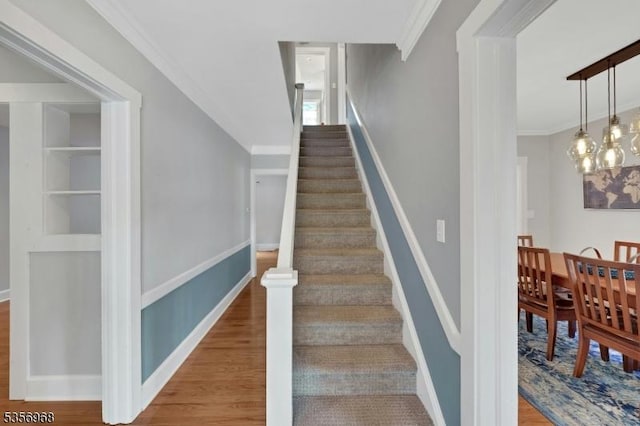 42 Mountain Ave, Mendham Boro, NJ 07945 - staircase featuring wood finished floors, crown molding, baseboards, and a chandelier