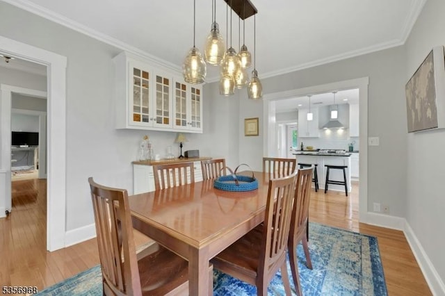 42 Mountain Ave, Mendham Boro, NJ 07945 - dining space with light wood-style floors, baseboards, ornamental molding, and a chandelier