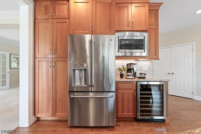 38 Southfield Dr, Montgomery Twp, NJ 08502 - kitchen with stainless steel appliances, beverage cooler, crown molding, wood finished floors, and light stone counters
