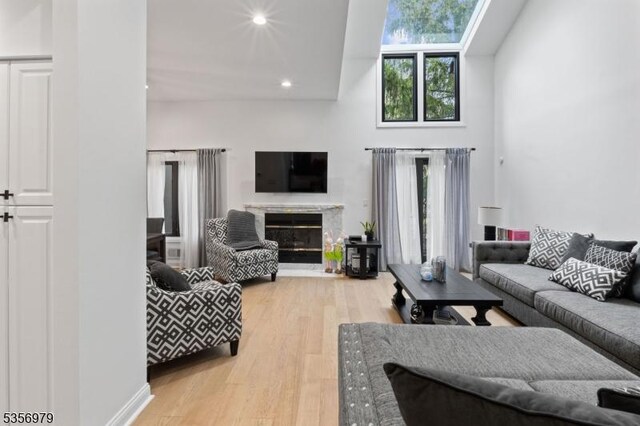 21 Stepping Rdg, North Caldwell Boro, NJ 07006 - living room with light wood-style flooring, a fireplace, recessed lighting, and a skylight