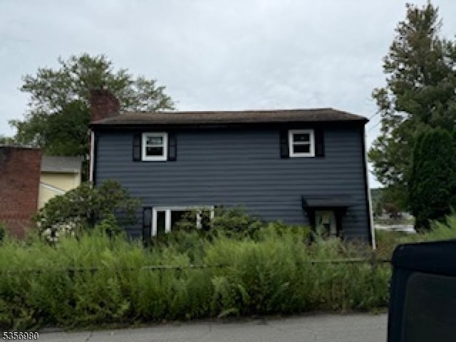 view of side of property with a chimney
