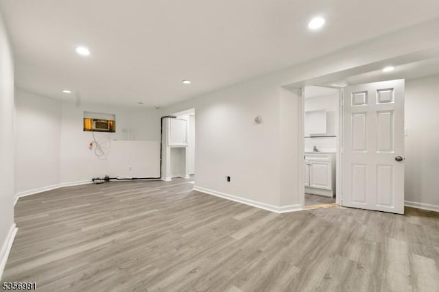 142 Sherman Ave, Newark City, NJ 07114 - unfurnished living room with light wood finished floors, baseboards, recessed lighting, and an AC wall unit
