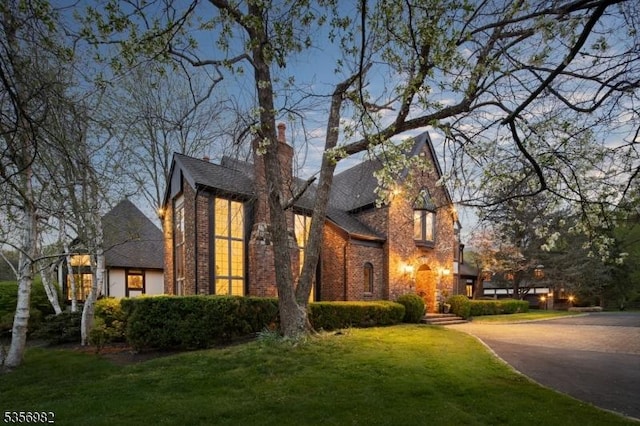 11 Kerby Ln, Mendham Boro, NJ 07945 - view of side of property featuring brick siding, a yard, and roof with shingles