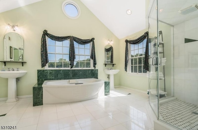 full bathroom with lofted ceiling, a shower stall, tile patterned flooring, a garden tub, and baseboards