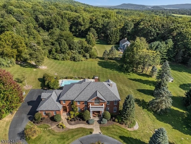 aerial view of property's location featuring a heavily wooded area
