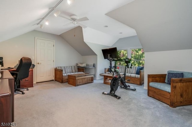 office with track lighting, vaulted ceiling, a ceiling fan, and light colored carpet