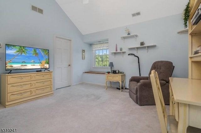 sitting room with light colored carpet and high vaulted ceiling
