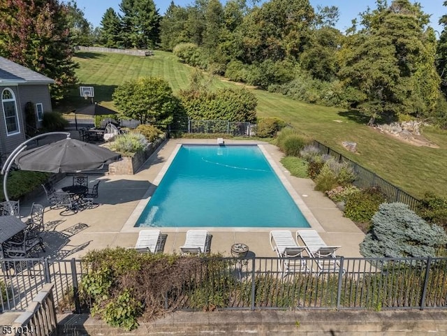 view of pool featuring a patio area and view of scattered trees