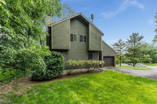 60 Dewey Ave, High Bridge Boro, NJ 08829 - view of home's exterior with asphalt driveway, a garage, a chimney, and a lawn