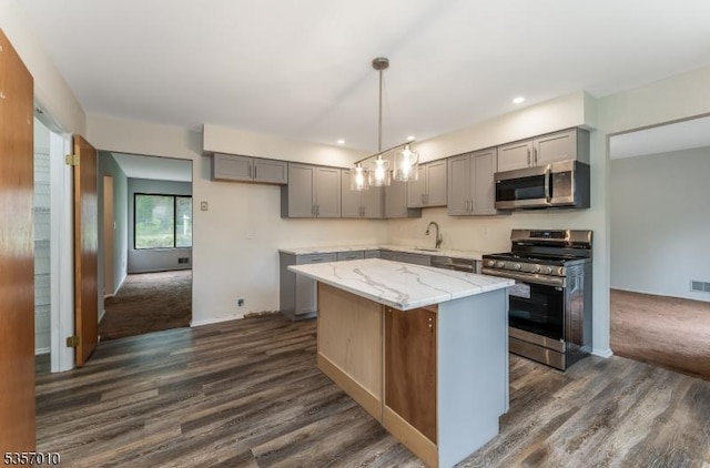 60 Dewey Ave, High Bridge Boro, NJ 08829 - kitchen with stainless steel appliances, gray cabinets, dark wood-style floors, a center island, and light stone counters