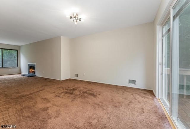 60 Dewey Ave, High Bridge Boro, NJ 08829 - unfurnished living room with carpet floors, a lit fireplace, and baseboards
