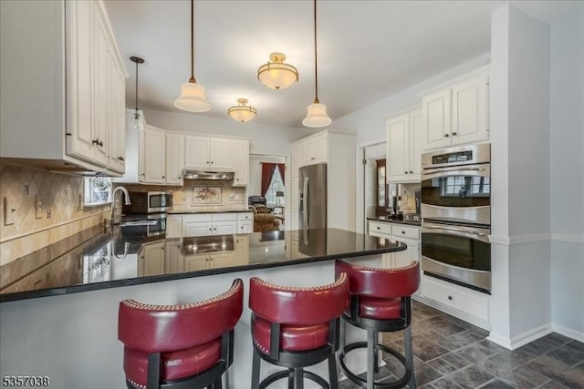 16 Dorset Ln, Andover Twp, NJ 07848 - kitchen featuring stainless steel appliances, a peninsula, a sink, dark countertops, and tasteful backsplash