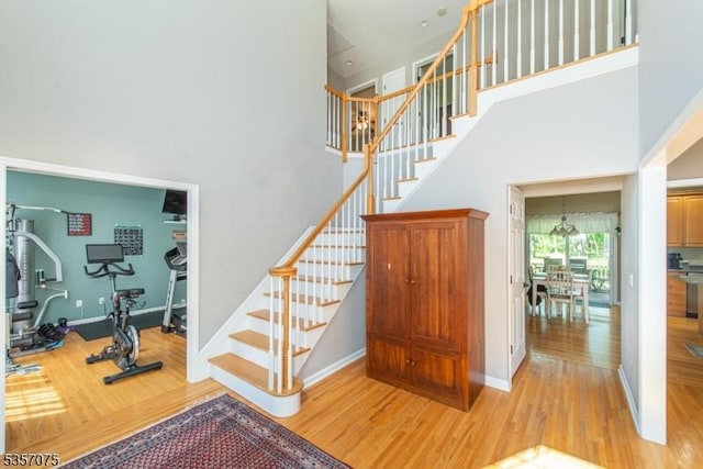 4 Ramsey Ct, Frelinghuysen Twp, NJ 07860 - staircase featuring wood finished floors, a towering ceiling, and baseboards
