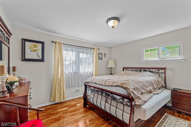 bedroom featuring wood finished floors and baseboards