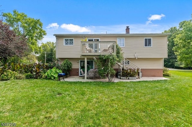 back of house featuring a patio area, a deck, a yard, a chimney, and stairway