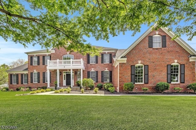 4 Frey Rd, Hillsborough Twp, NJ 08844 - colonial-style house with a balcony, brick siding, and a front yard