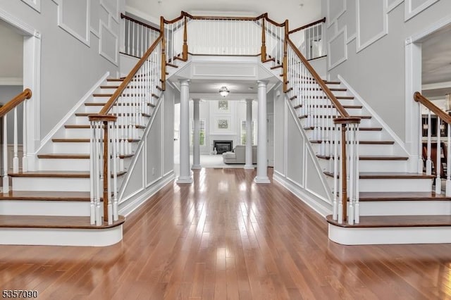 4 Frey Rd, Hillsborough Twp, NJ 08844 - foyer with ornate columns, stairs, hardwood / wood-style floors, a high ceiling, and a decorative wall