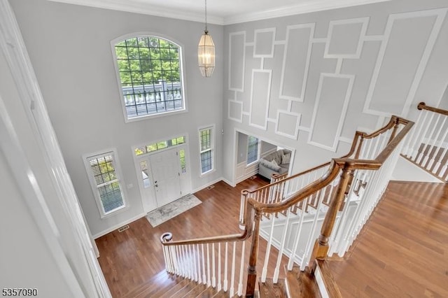 4 Frey Rd, Hillsborough Twp, NJ 08844 - entryway featuring wood finished floors, a chandelier, ornamental molding, baseboards, and a towering ceiling