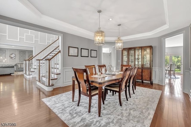 4 Frey Rd, Hillsborough Twp, NJ 08844 - dining space with a raised ceiling, a decorative wall, hardwood / wood-style floors, stairway, and a wainscoted wall