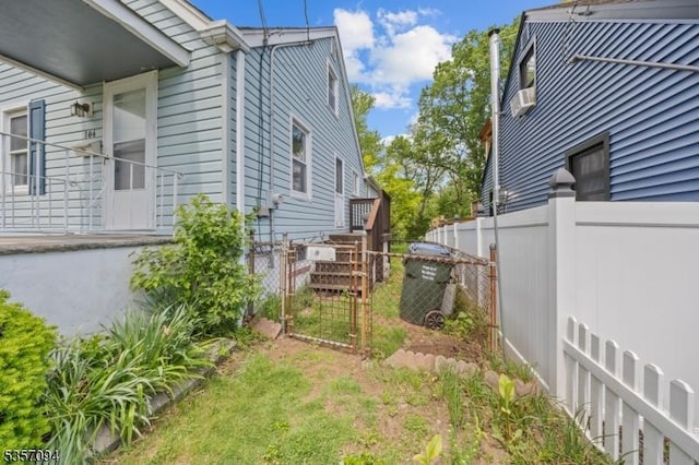 view of yard with fence and a gate