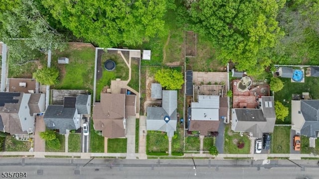 aerial view of property and surrounding area featuring nearby suburban area