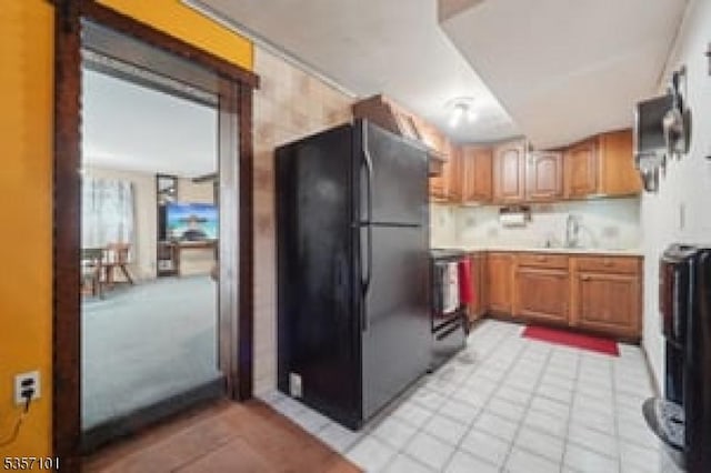 8 Oak Ave, Denville Twp, NJ 07834 - kitchen with freestanding refrigerator, light countertops, brown cabinets, and light tile patterned floors