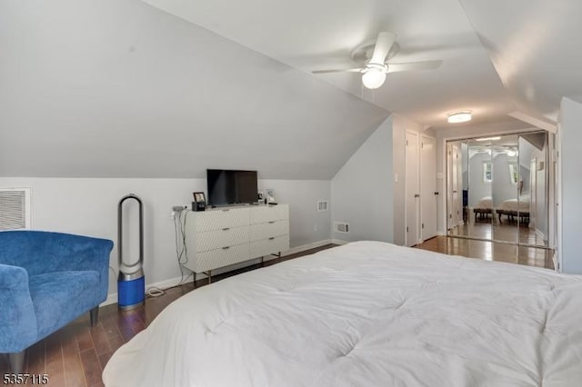 bedroom with baseboards, vaulted ceiling, wood finished floors, and ceiling fan